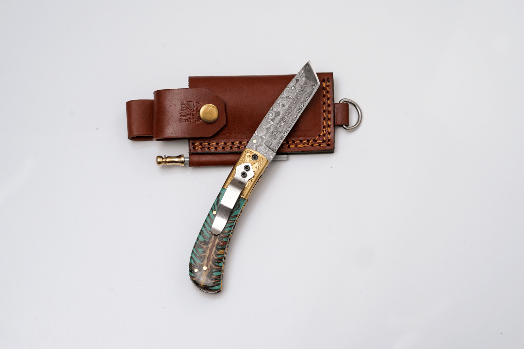 Titan International Titan International - Hand-Forged Damascus Tanto Folder | Teal Pine Cone Handle with Engraved Brass Bolster & Fire Starter